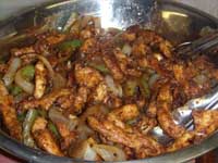 Mixing the COoked Vegetables with the Chicken Picture